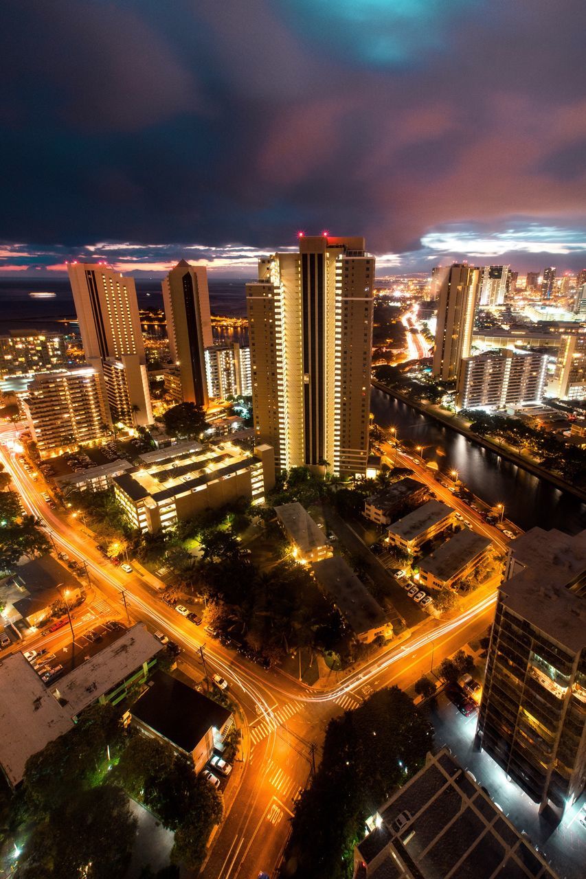 city, illuminated, cityscape, night, skyscraper, building exterior, architecture, high angle view, dusk, urban skyline, modern, city life, outdoors, aerial view, sunset, built structure, travel destinations, sky, dramatic sky, no people, futuristic, business finance and industry, downtown district, nightlife