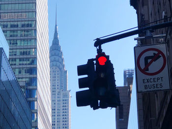 Low angle view of road sign against sky