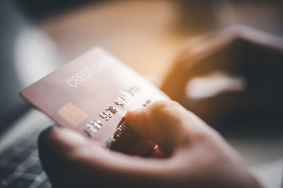 Cropped hand of woman using mobile phone