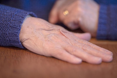 Close-up of hands on table