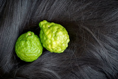 High angle view of green fruits against black background