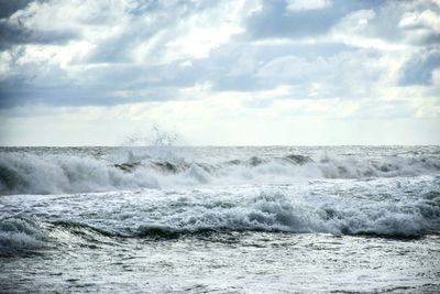 Scenic view of sea against cloudy sky