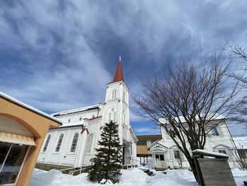 Low angle view of building against sky during winter