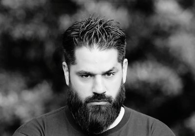 Close-up portrait of serious bearded man