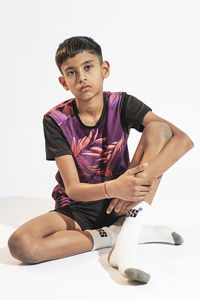 Young woman exercising against white background