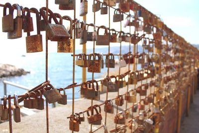 Close-up of padlocks hanging on railing