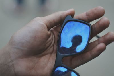 Close-up of hand holding mobile phone