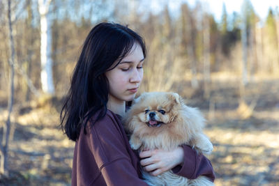 Portrait of young woman with dog