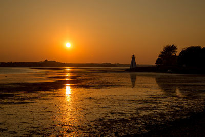 Scenic view of sea against orange sky