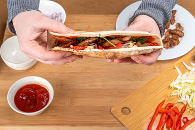 Cropped hand of woman holding food