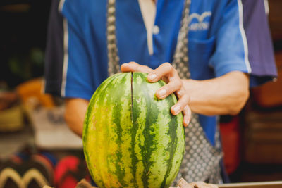 Close-up of man holding fruit