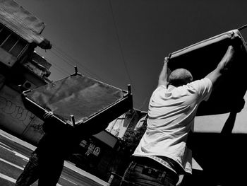 Rear view of men moving furniture