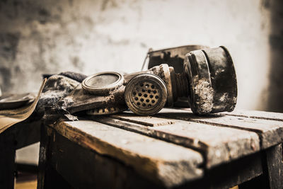 Close-up of old gasmask on wooden table