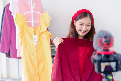 Portrait of a smiling young woman standing in store