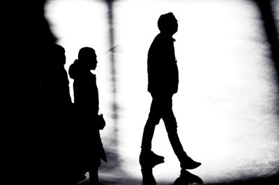 Silhouette people with arms raised