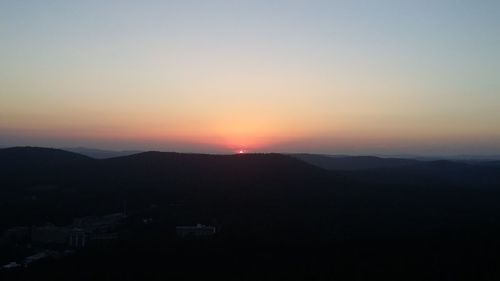 Scenic view of silhouette mountains against sky at sunset