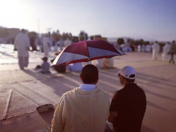 Rear view of people walking in city