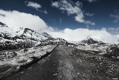 Scenic view of mountains against cloudy sky