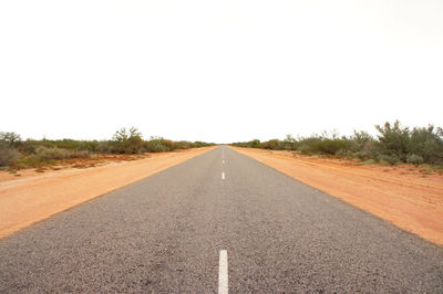 Surface level of road against clear sky