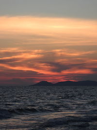 Scenic view of sea against romantic sky at sunset