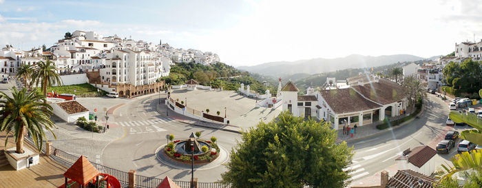 High angle view of townscape by road against sky