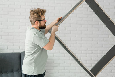 Rear view of man standing against wall