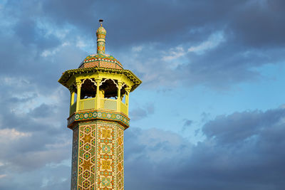 Low angle view of bell tower against sky