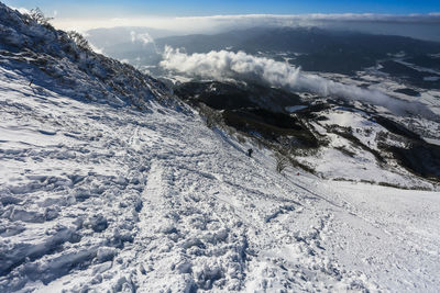 Scenic view of snow covered mountains against sky