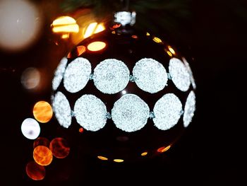 Close-up of illuminated lights against black background