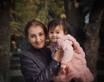 Portrait of mother and daughter outdoors