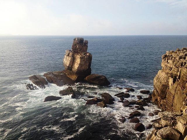 SCENIC VIEW OF SEA WITH ROCKS IN BACKGROUND