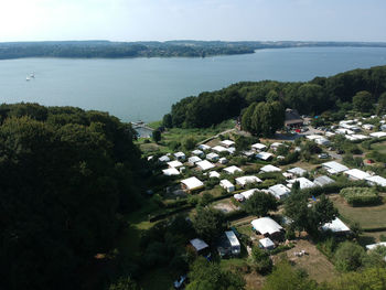 High angle view of sea and buildings against sky