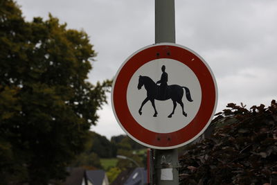 Road sign against sky