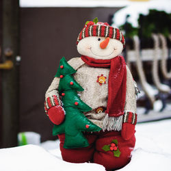 Close-up of christmas decorations in snow