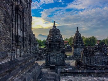 Statue of temple against cloudy sky