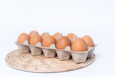 View of eggs in container against white background