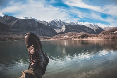 Man in lake against mountains