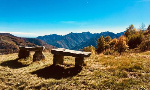 Scenic view of mountains against blue sky