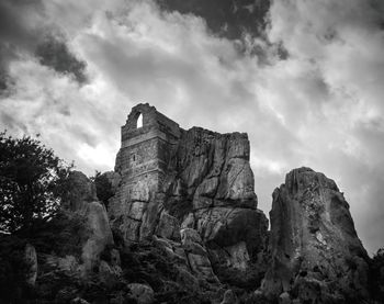 Low angle view of rock formation against sky