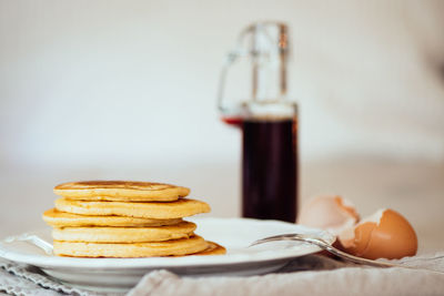 Close-up of pancakes served in plate on table