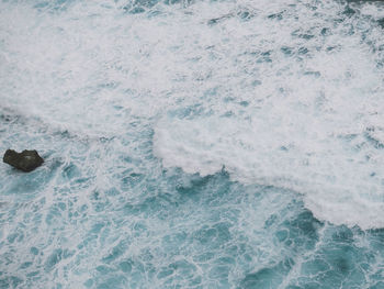 High angle view of waves breaking on beach