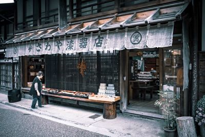 Side view of a man walking on street in city