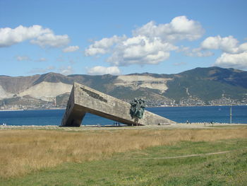Scenic view of land and mountains against sky