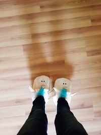 Low section of woman standing on hardwood floor