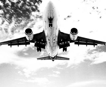 Low angle view of airplane flying against sky