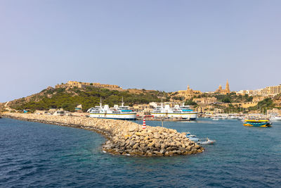 Panoramic view of sea and buildings against clear sky