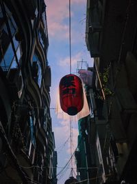 Low angle view of lanterns hanging against sky