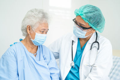 Portrait of female doctor examining x-ray at clinic