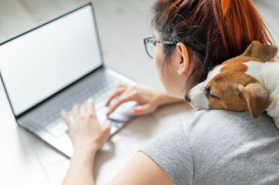 Young woman using laptop at home