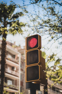 Low angle view of traffic lights   against sky